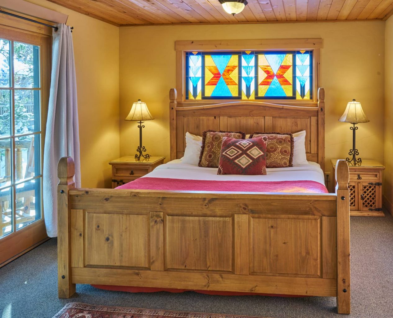 King Bed in the Mariposa Cabin with door leading to a private deck