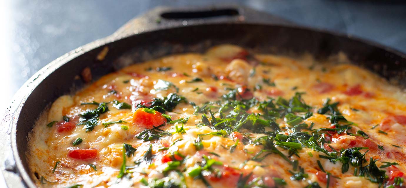 Omelet with herbs in cast iron pan