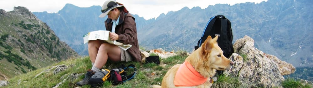 A person with their dog on a hike